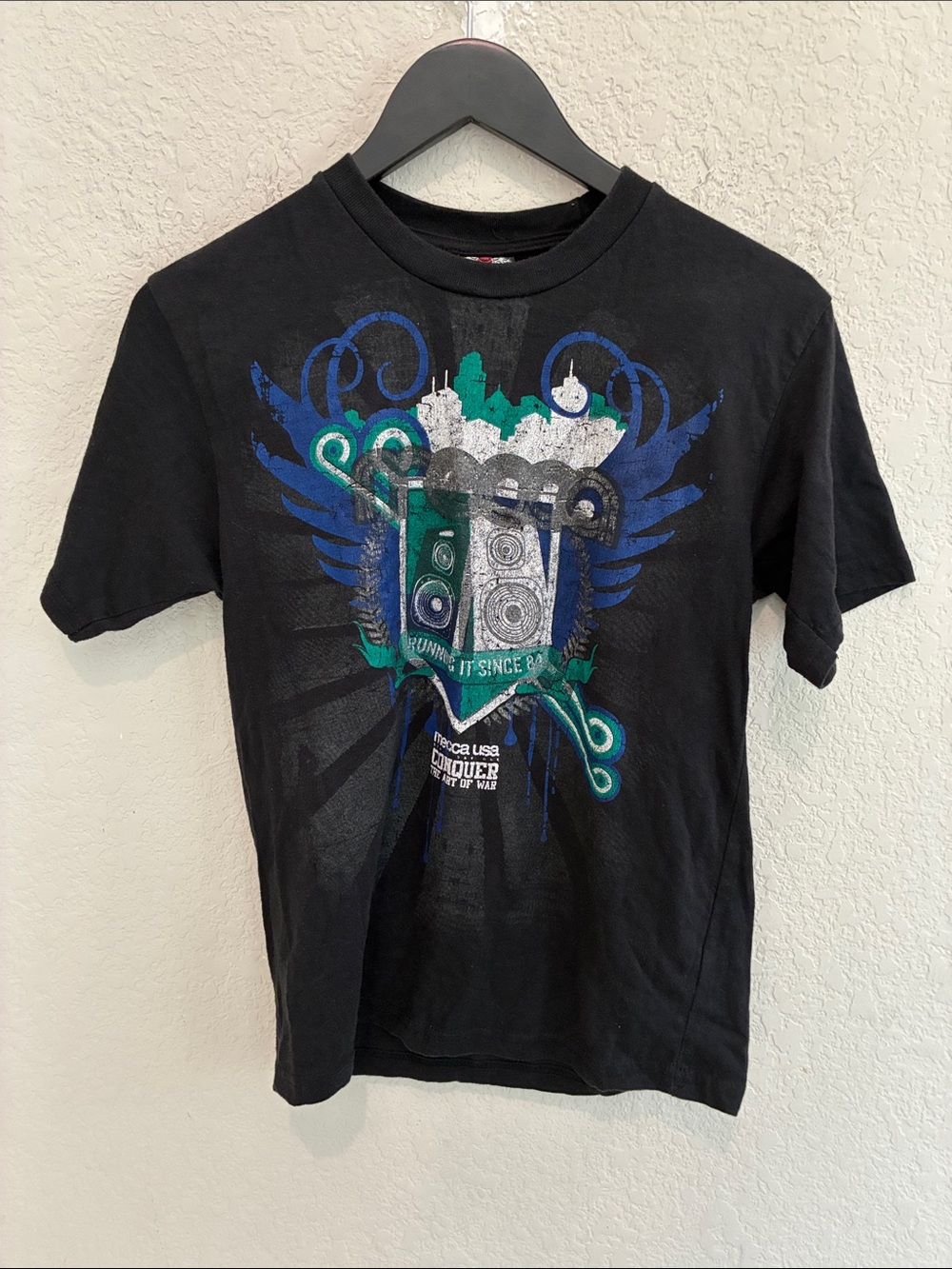 Mecca Black Tee with Teal and Royal Blue Speaker Crest